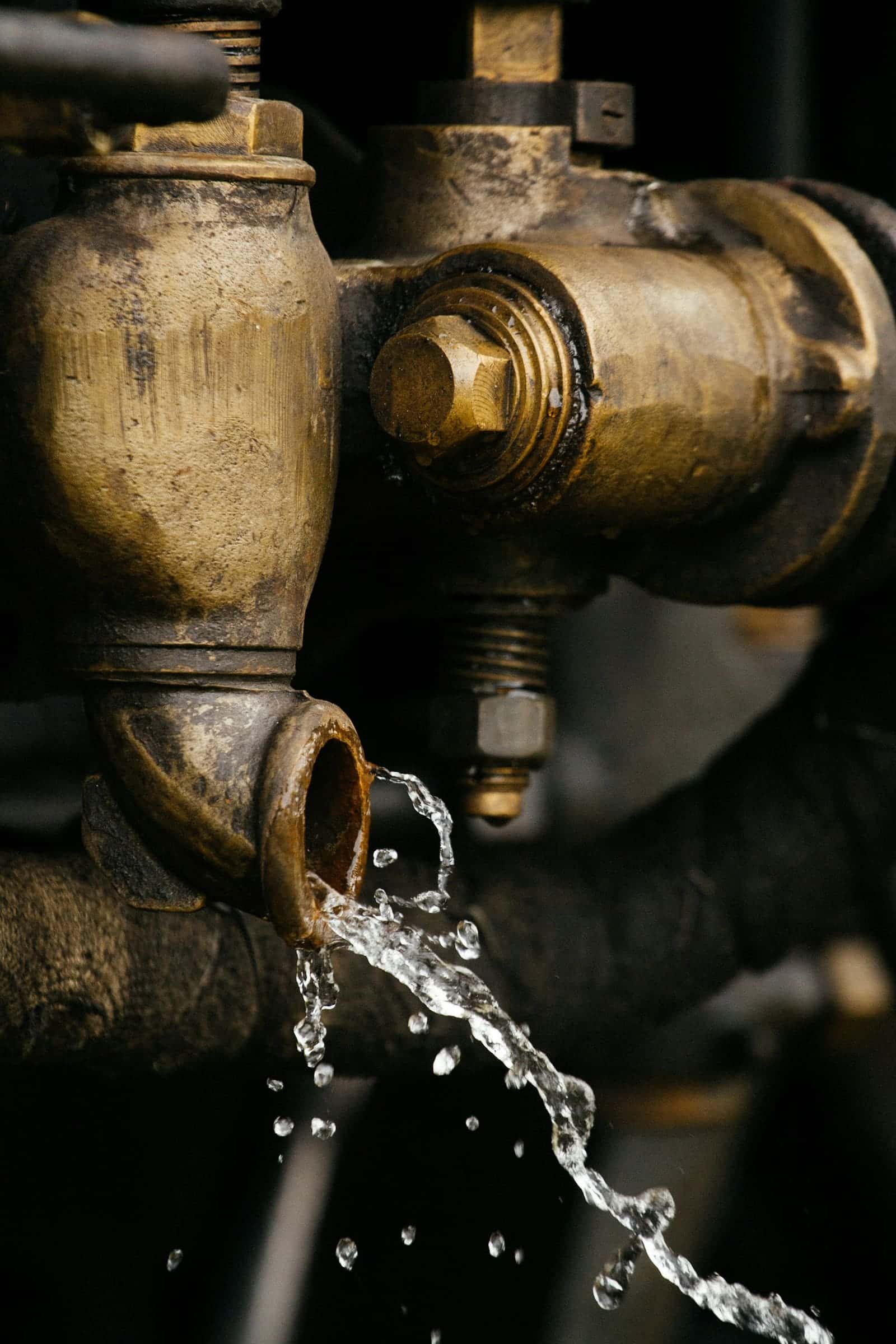 Water dripping from a corroded brass valve